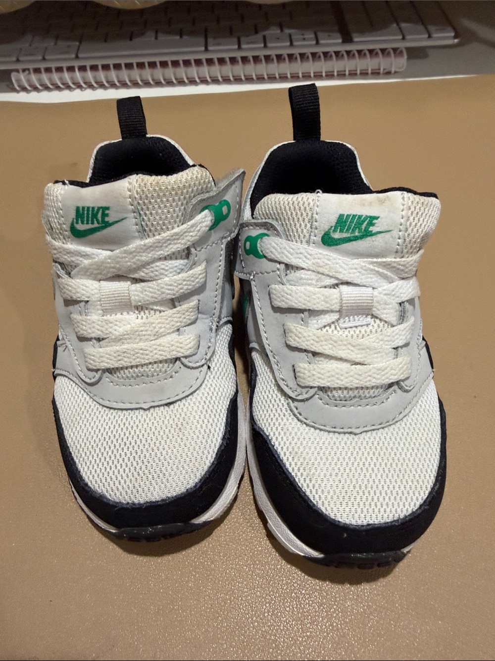 Nike Kids White Sneakers with Black Trim and Green Logo
